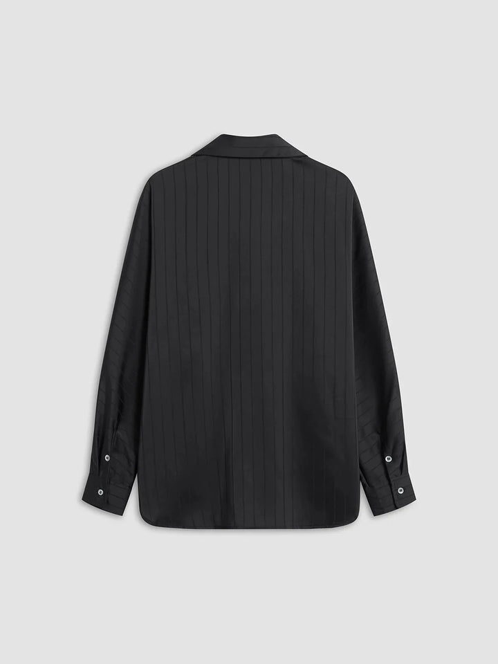 "Alaura button-up shirt with gold accents, featuring sleek design and quality fabric."