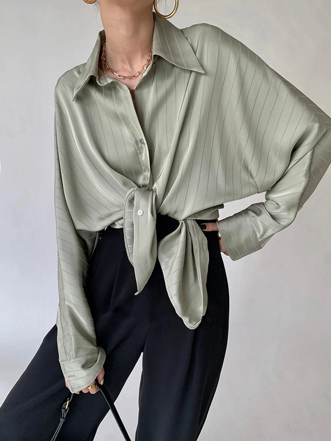 Sleek button-up shirt in Alaura with striking gold accents, made of soft cotton blend, perfect for everyday wear or a…