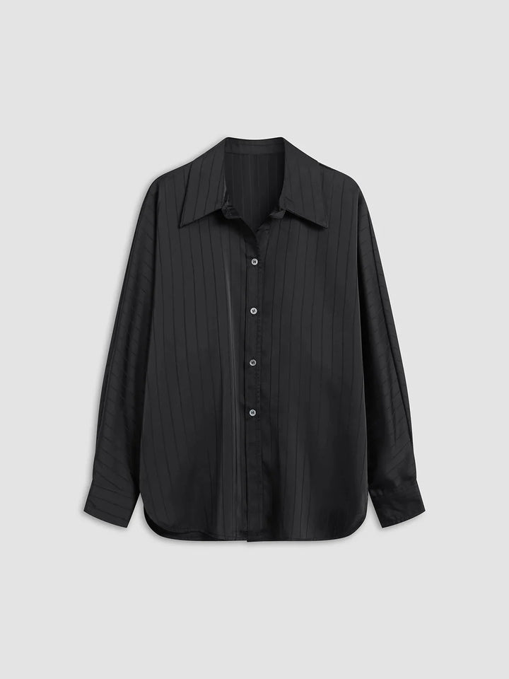 Button-up blouse in Alaura with gold accents, tailored design, and sleek silhouette for a sophisticated look.
