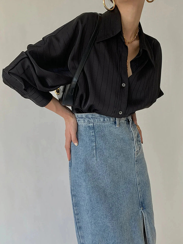 Black button-up shirt with gold accents and a sleek design by Alaura.