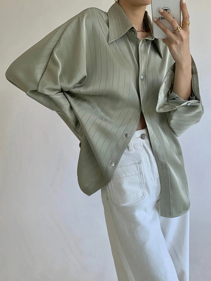 Green Alaura button-up shirt with elegant gold accents, crafted from a soft and lightweight fabric with a slim fit design.