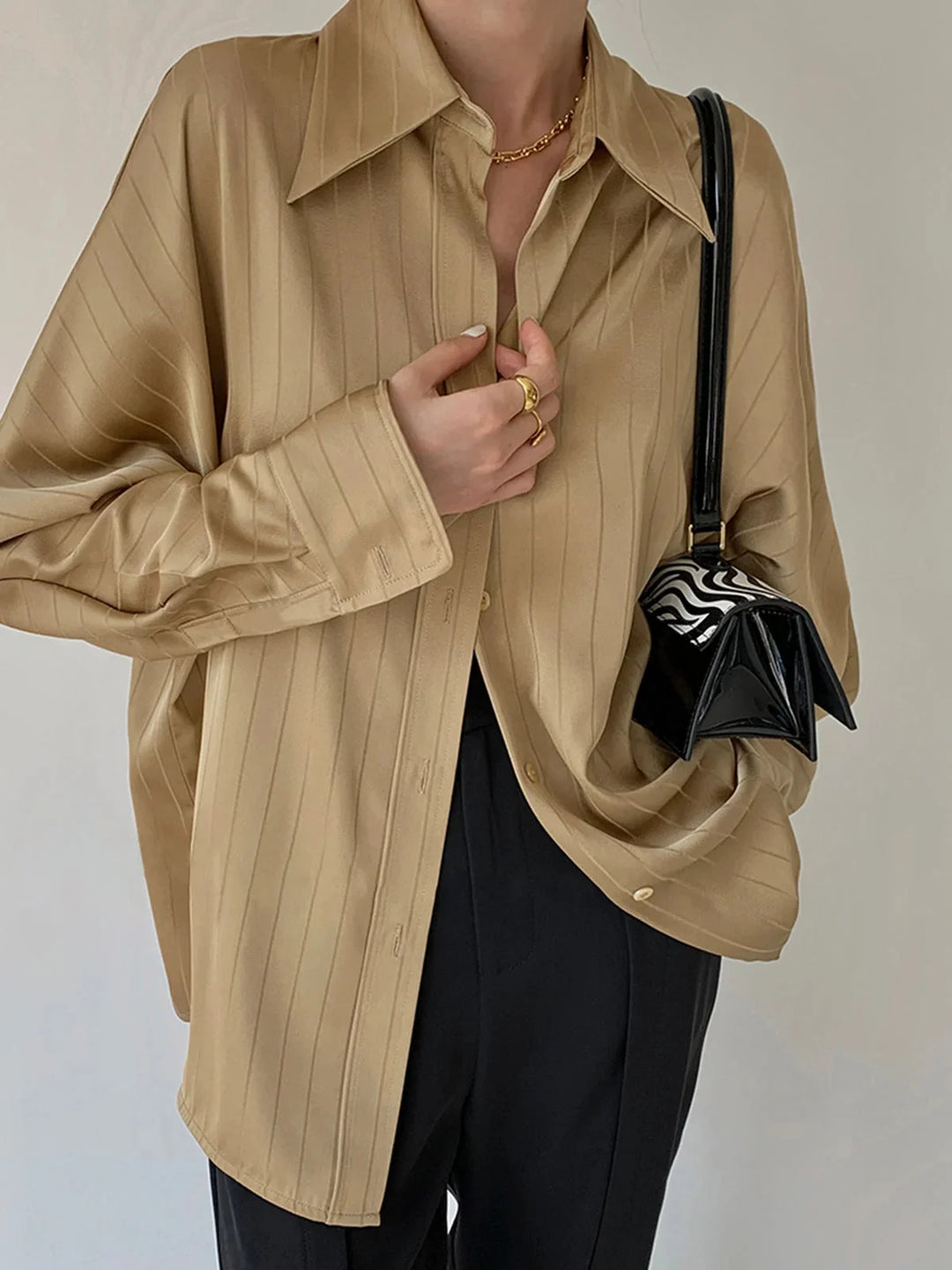 Yellow Alaura button-up shirt with gold detailing, made from soft cotton blend. Sleek design with unique gold accents.