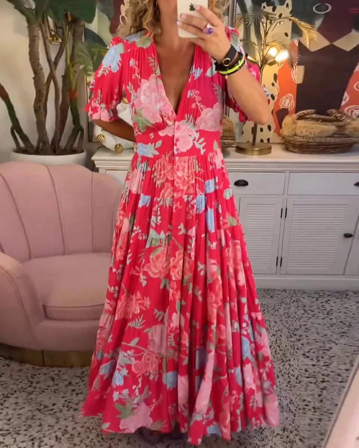 Women's Maja dress in floral print with V-neck and flowy midi skirt, perfect for a breezy day out or special occasion.