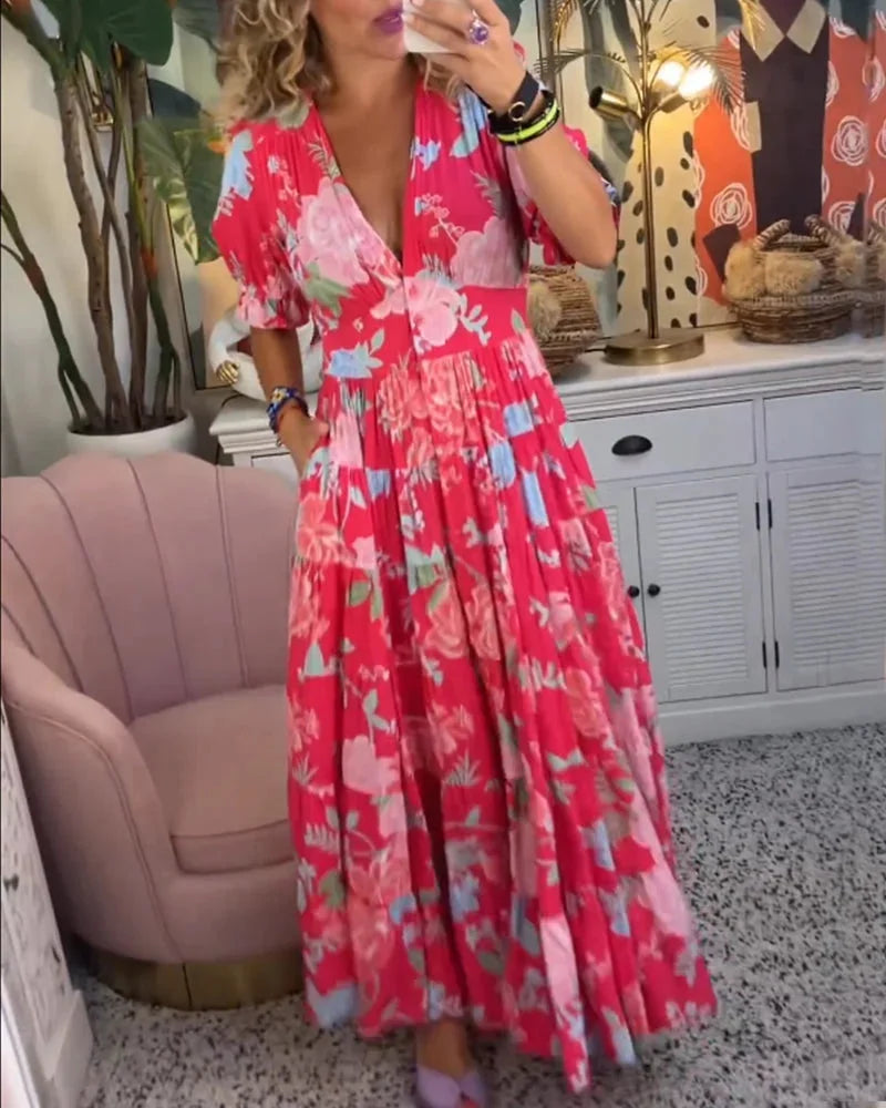 "Maja floral midi dress with V-neck and flowy skirt, perfect for a summer day with its lightweight and airy fabric."