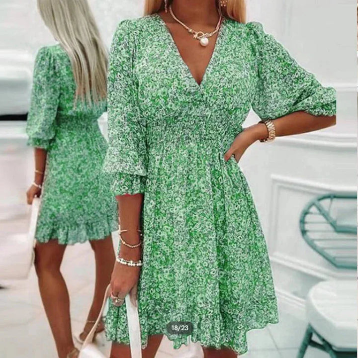 Green v-neckline floral Boho dress by Soléna. Made from soft cotton with a relaxed silhouette and intricate floral pattern.