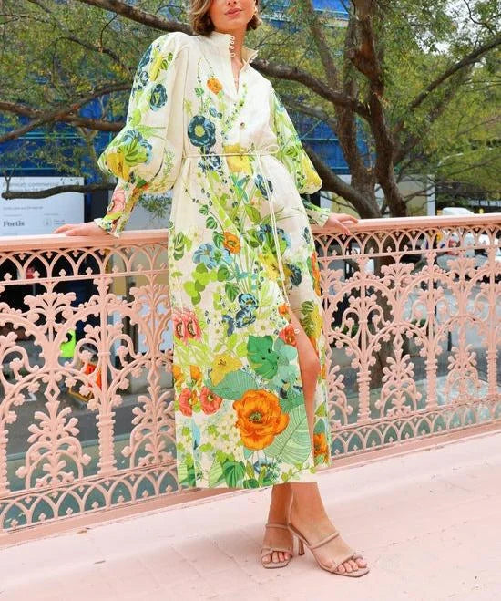 Flowy sleeveless maxi shirt dress with vibrant floral pattern on light, breathable fabric, perfect for effortless summer…