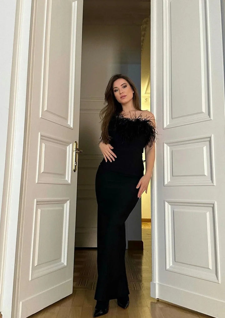 Black strapless dress with feather trim, perfect for a special occasion. Rich texture and exquisite detailing add elegance…