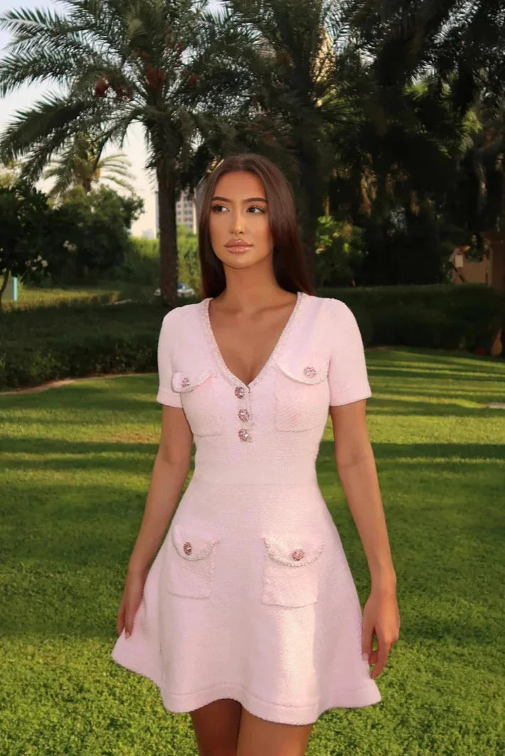 Pink short dress with buttons and pockets, made of soft cotton blend. Perfect for a casual yet stylish look.