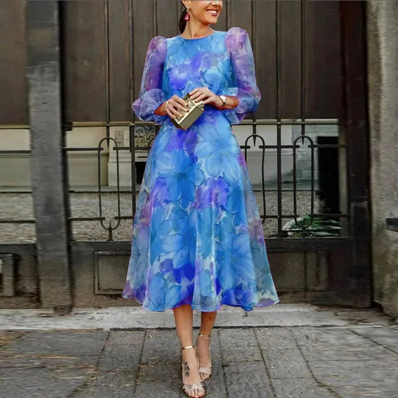 Blue floral print midi dress with sheer sleeves, perfect for a feminine and elegant look.