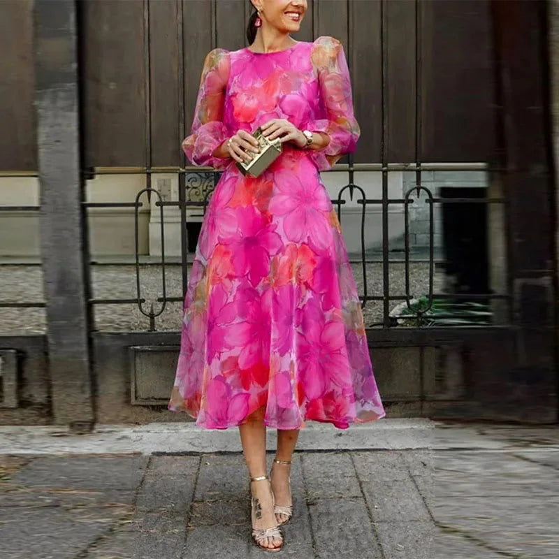 Pink floral print midi dress with sheer sleeves, perfect for a summer day out. Feminine and elegant design, ideal for any…