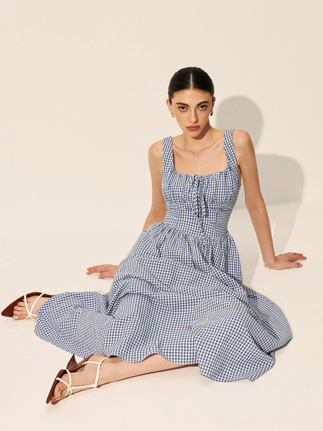 "Navy gingham cotton maxi dress with sleeveless design for a relaxed and stylish look."