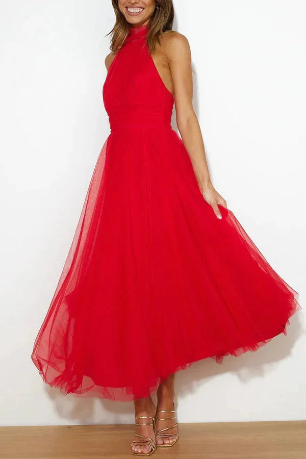 Kayla halter neck midi dress in a pleated design, perfect for special occasions, made from a lightweight and flowy fabric.