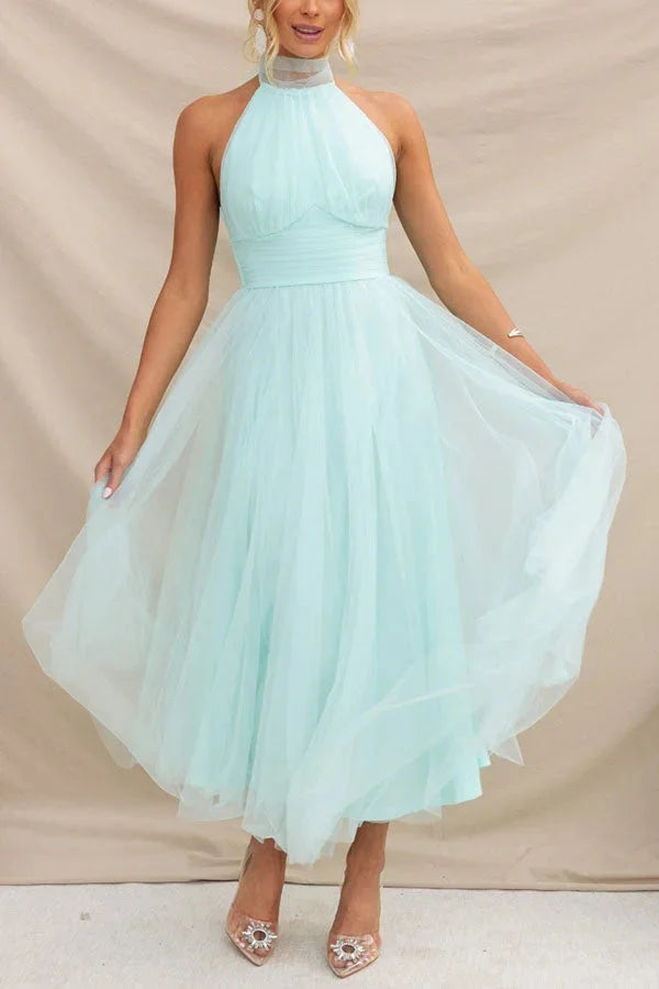Light blue pleated midi dress with a halter neck design by Kayla. Made from soft and flowy fabric, perfect for both…