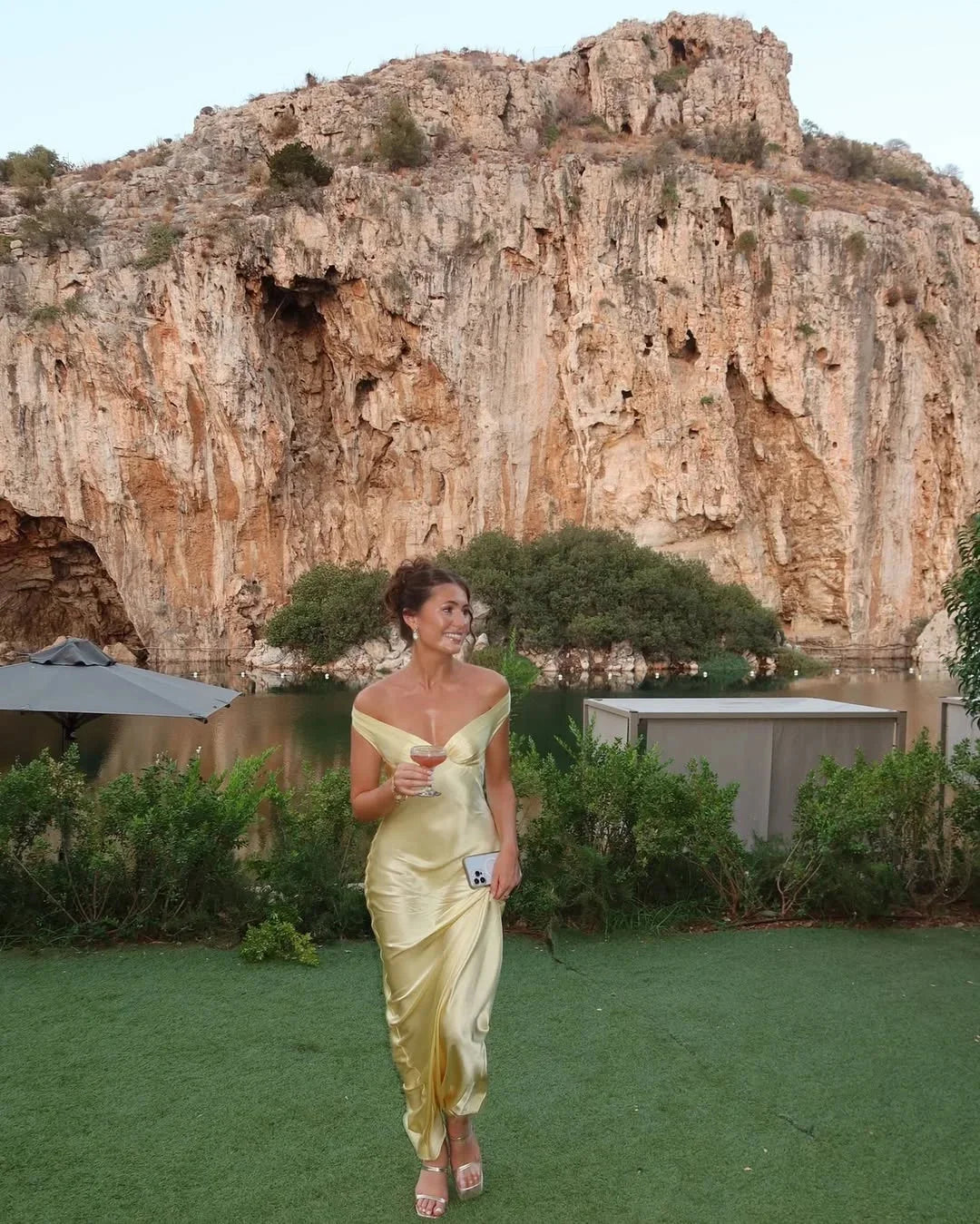 Cream maxi dress with off-shoulder design by Poppi, paired with a matching clutch. Perfect for elegant occasions with a…