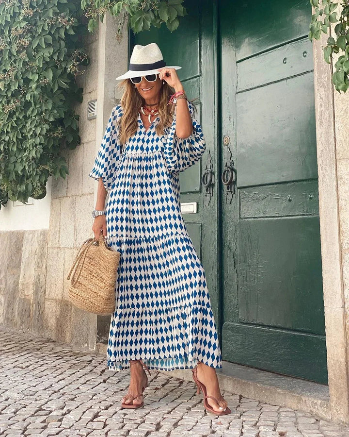 Jenelle maxi dress featuring a playful print design, made of lightweight and breathable fabric perfect for summer days.