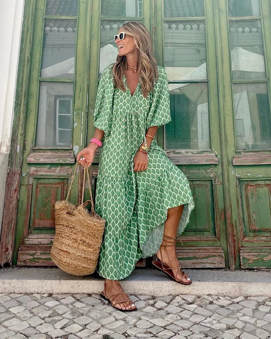 Green and white maxi dress by Jenelle featuring a playful print design. Made from soft, breathable fabric for a comfortable…