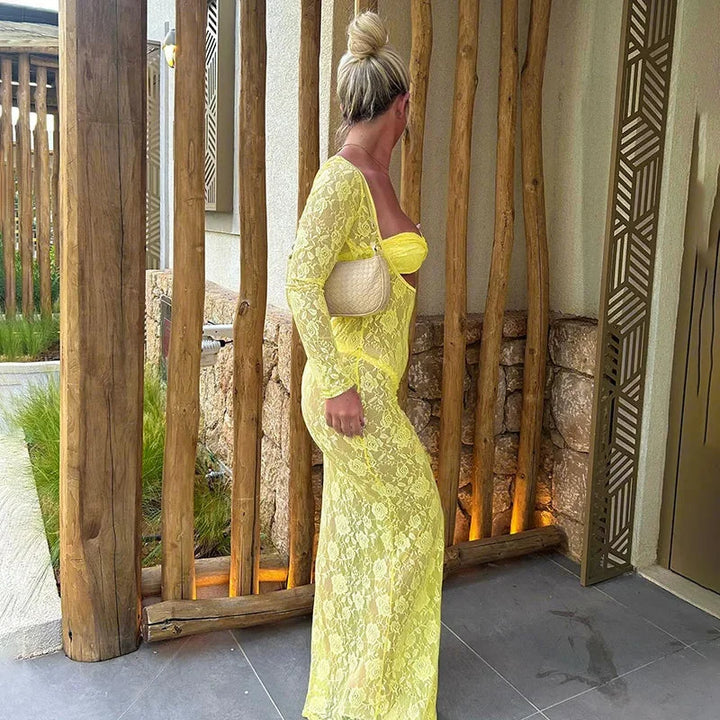 Yellow lace dress with cutouts in long sleeves, showcasing intricate design.