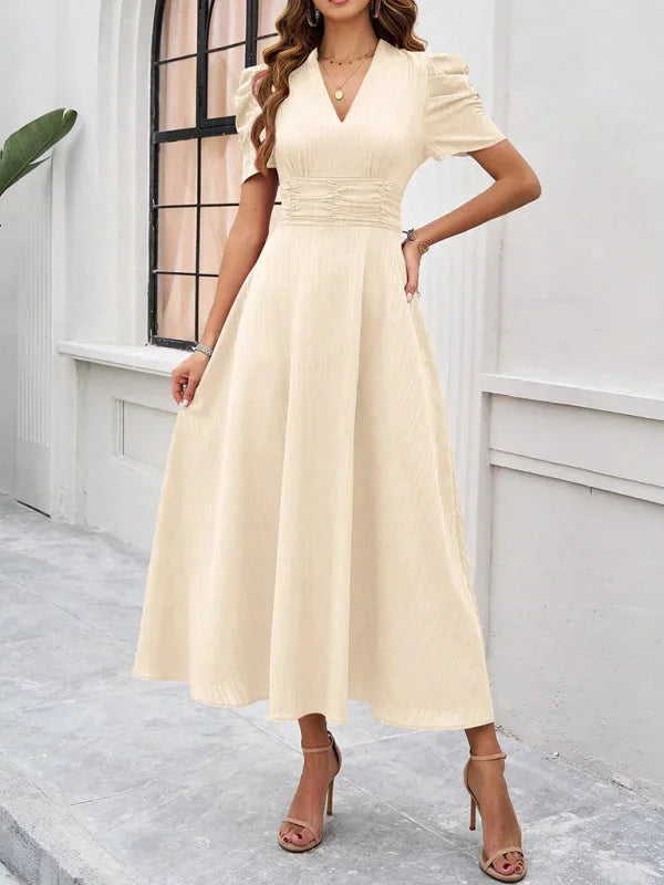 Khaki flowy midi dress with puff sleeves and V-neck. Feminine and versatile design perfect for various occasions.