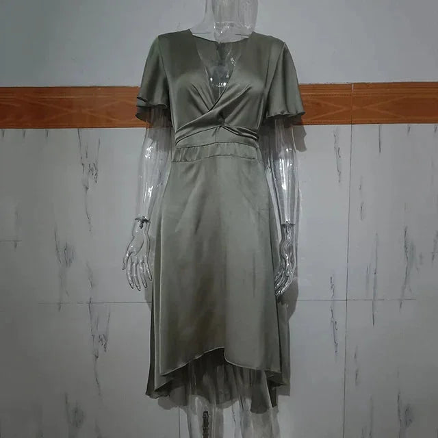 "Adela midi dress in a striking asymmetrical design with flutter sleeves, perfect for effortless chic looks."