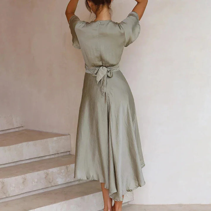 Adela midi dress in black, asymmetric cut with flutter sleeves, perfect for casual or dressed-up occasions.