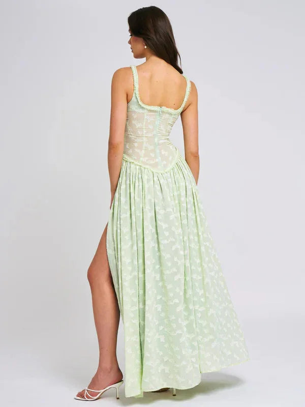 "Bernice maxi dress in green with floral print and side slit, perfect for a chic and breezy summer look."