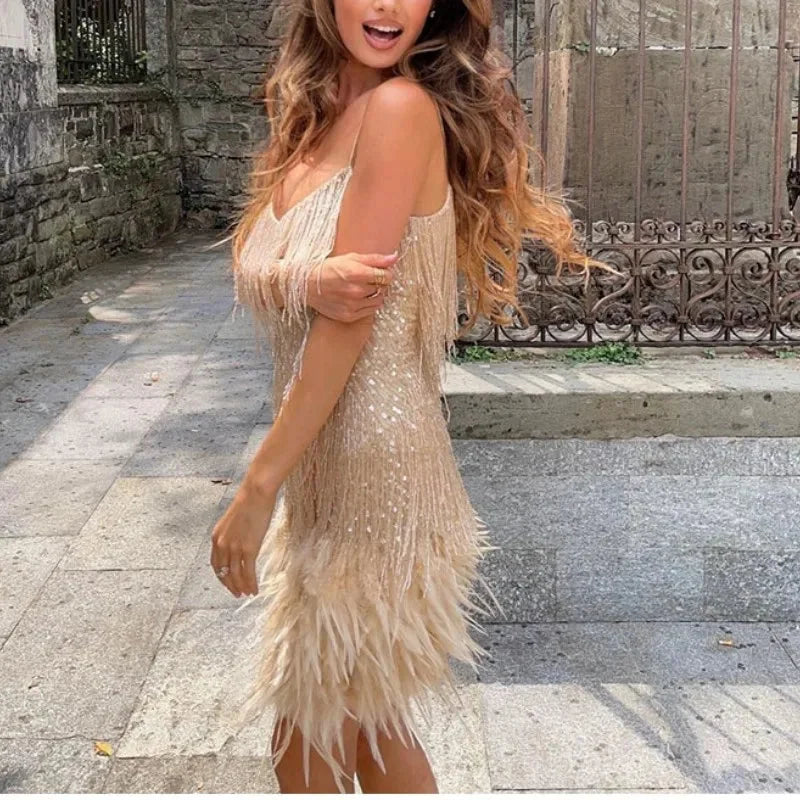 Beige mini dress with feathered detailing, adjustable straps.