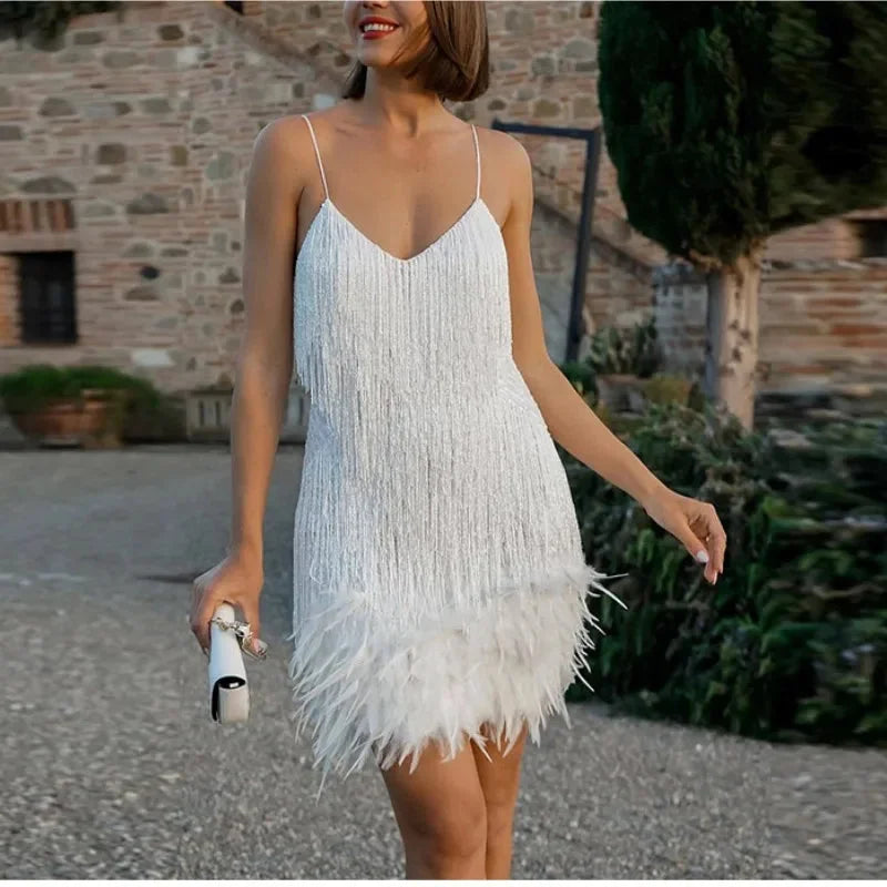 White feathered mini dress with adjustable straps. Elegant and chic design perfect for special occasions.