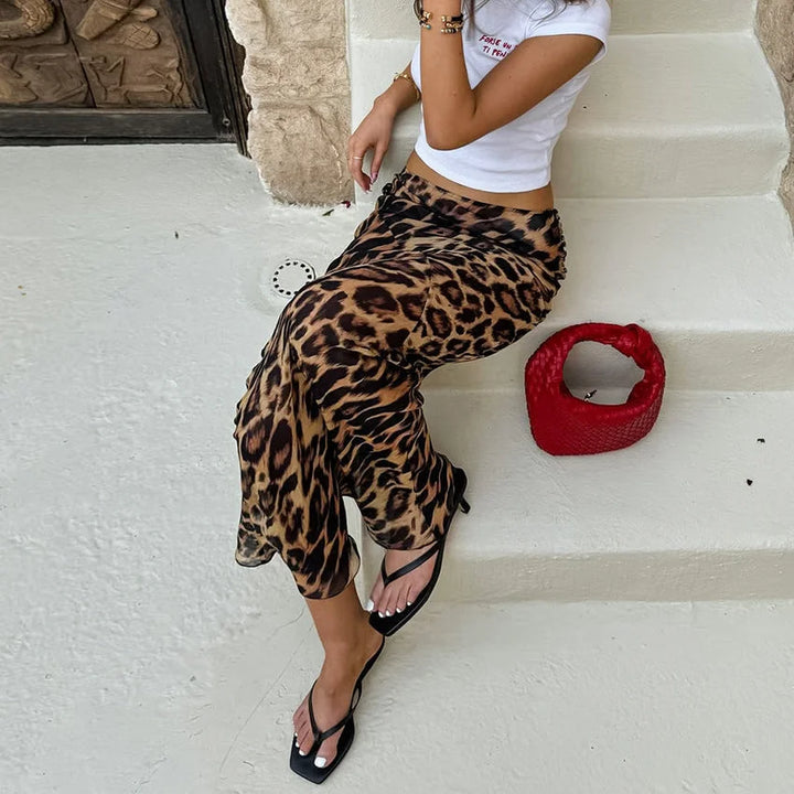 "Black and white floor-length animal print skirt for women, featuring a lightweight and flowy fabric with a high-waist…