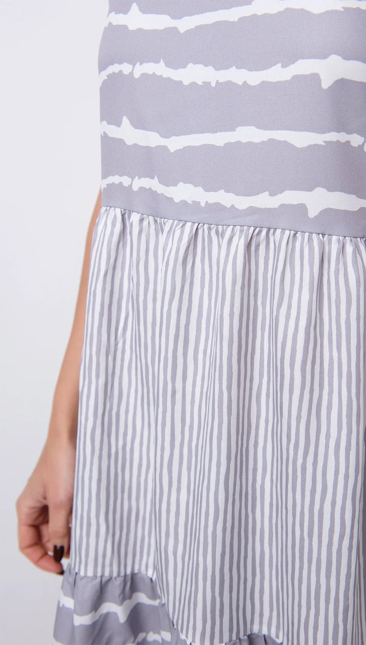 "Grey sleeveless dress with tiered design, perfect for summer days. Made from soft and breathable fabric."