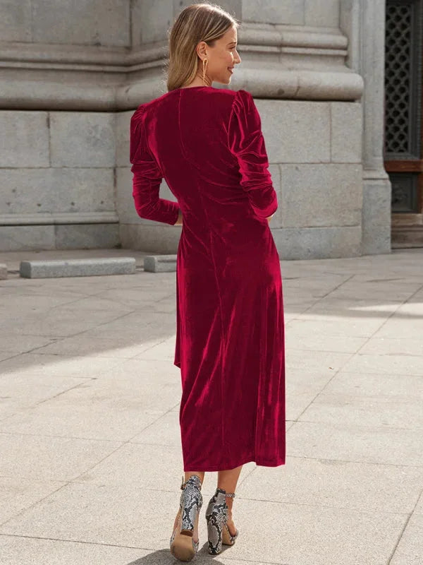Angeles velvet wrap dress in deep blue with puffed sleeves, perfect for special occasions and evening events.