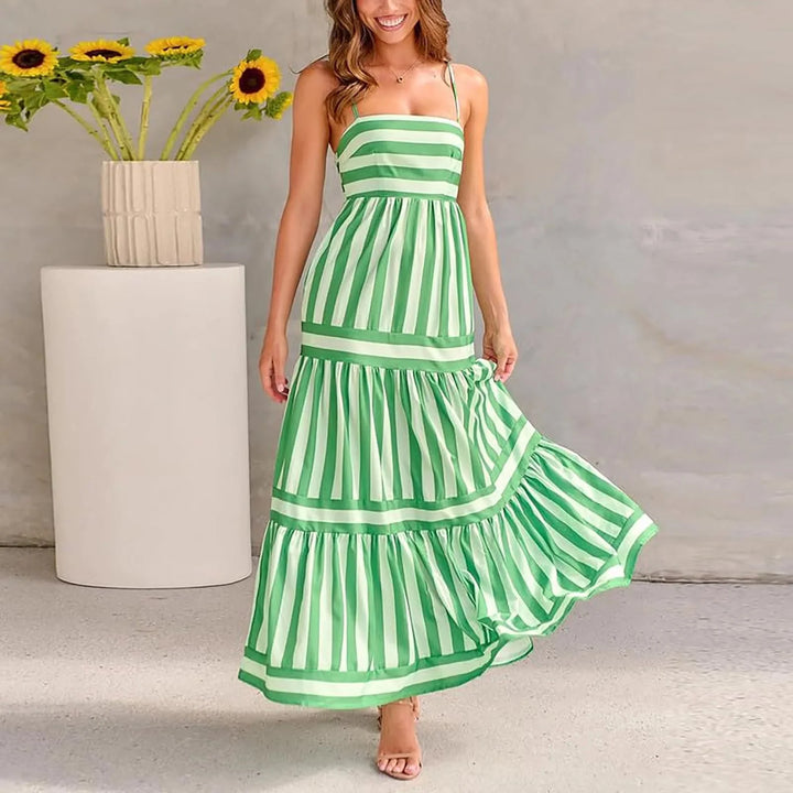 "Striped tiered maxi dress in soft cotton with adjustable shoulder straps in blue and white hues."