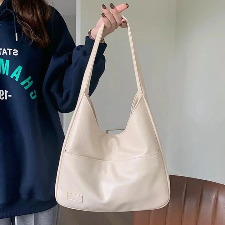 "Sleek black shoulder bag with minimal design and adjustable strap, perfect for everyday use."