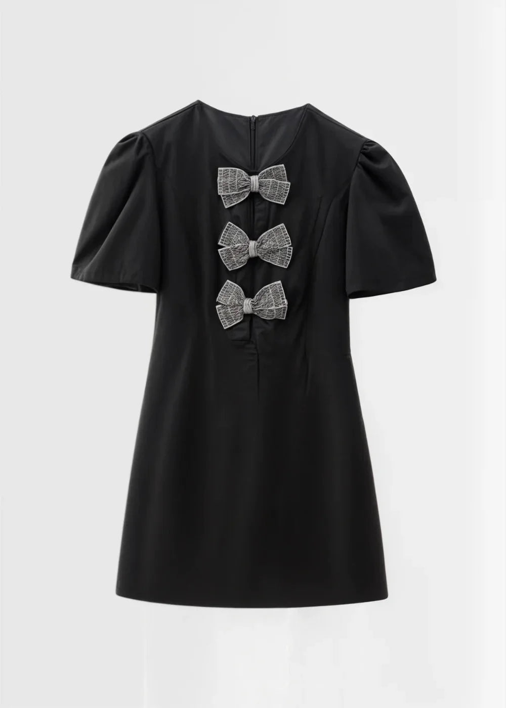 "Toby mini dress with puff sleeves and bows, made from soft and elegant fabric in a flattering A-line silhouette."