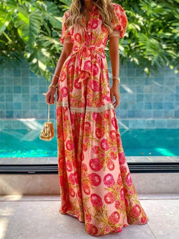 "Adalena coral pink floral dress featuring delicate lace detailing, perfect for a summery feminine look."