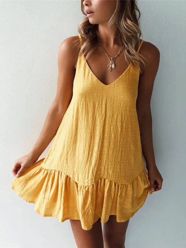 Yellow V-neck dress with ruffled details by Calani. Made of light, flowy fabric perfect for summer outings.