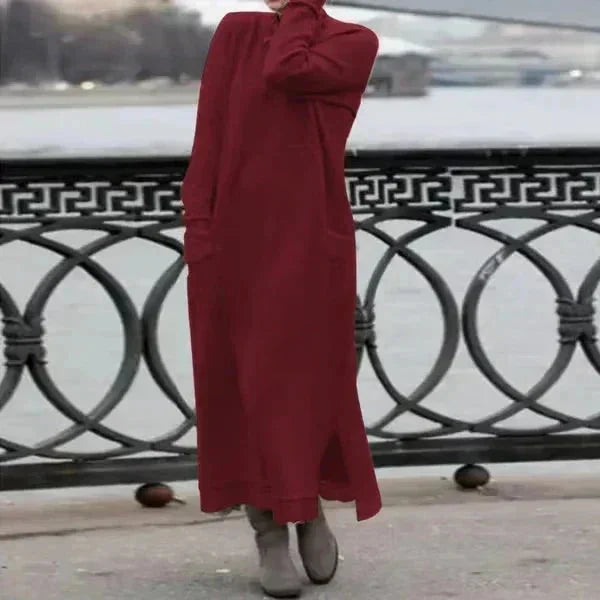 Red ankle-length winter attire by Carina with cozy knitted texture and faux fur collar for warmth and style.