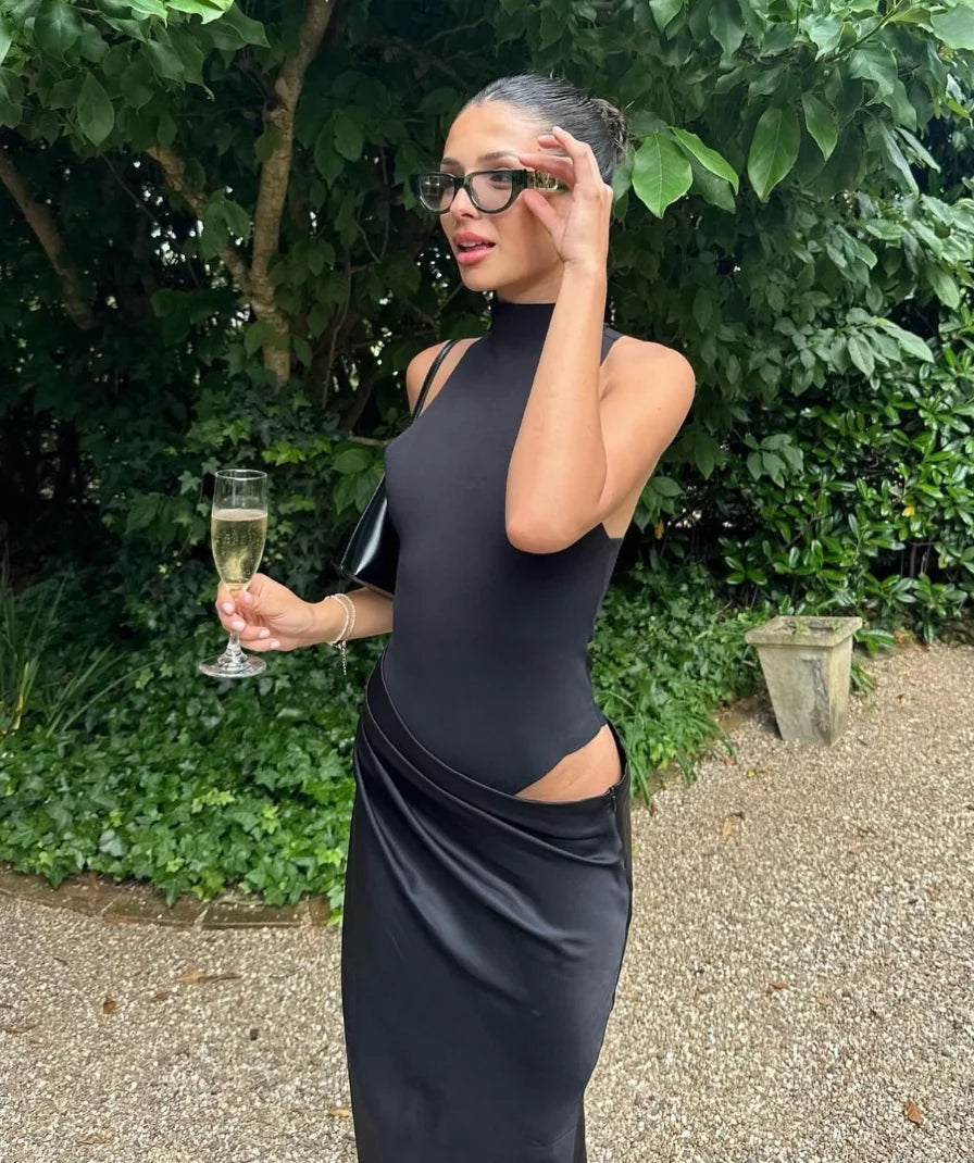 Kenya halter neck maxi dress in black, featuring stylish cut-outs and a flowy design, perfect for a chic and elegant look.