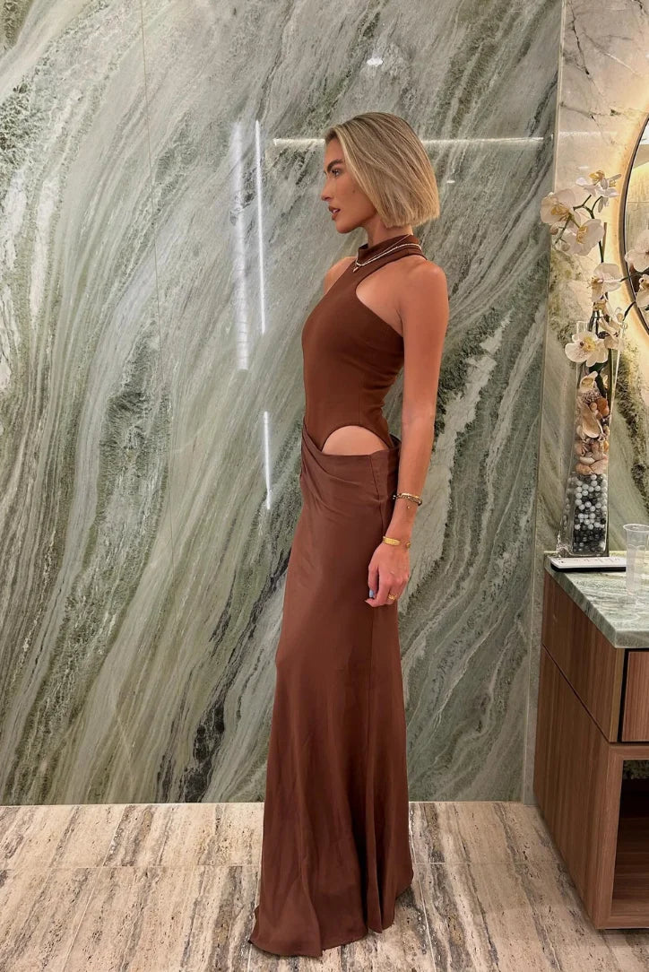 "Black halter neck maxi dress with side cut-outs, perfect for summer days. Soft and flowy fabric drapes beautifully."