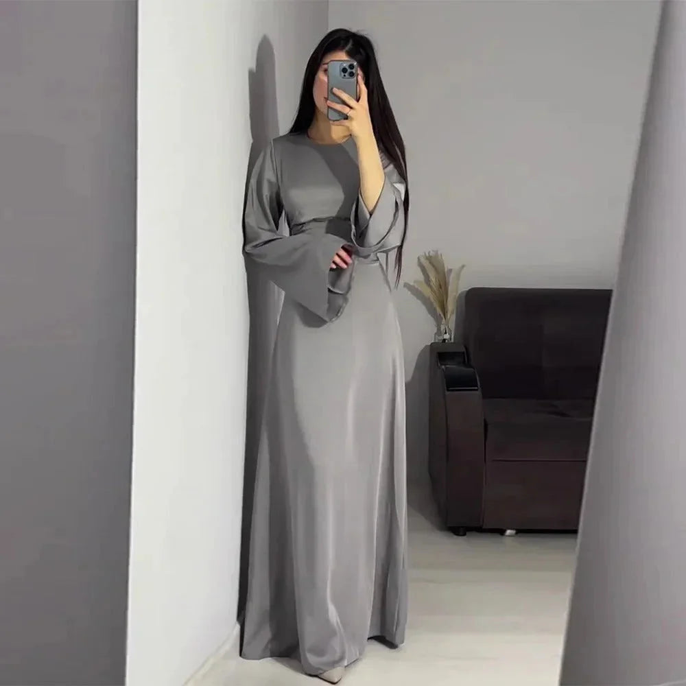 Gray floor-length dress with bell sleeves, offering a unique and elegant design perfect for formal occasions.