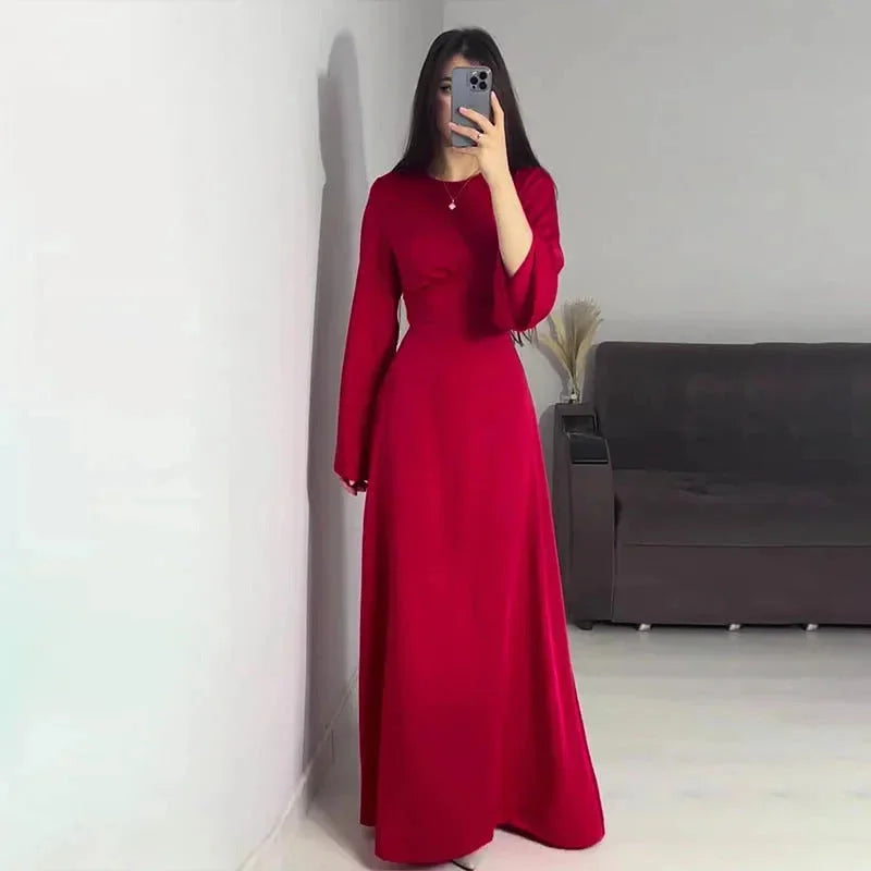 Red floor-length dress with bell sleeves made from flowing chiffon fabric. Features elegant design perfect for any formal…