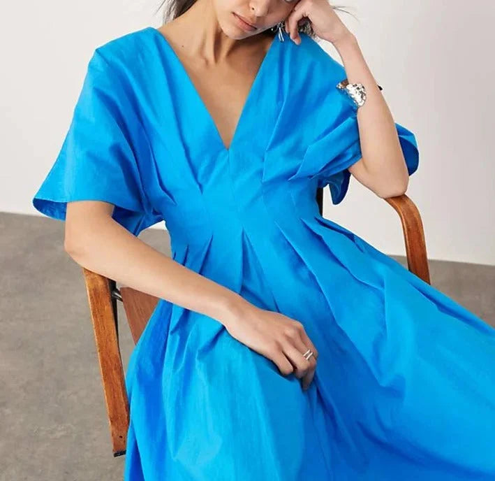 "Justine V-neck dress in vibrant blue with kimono sleeves and midi length, perfect for a casual yet elegant look."