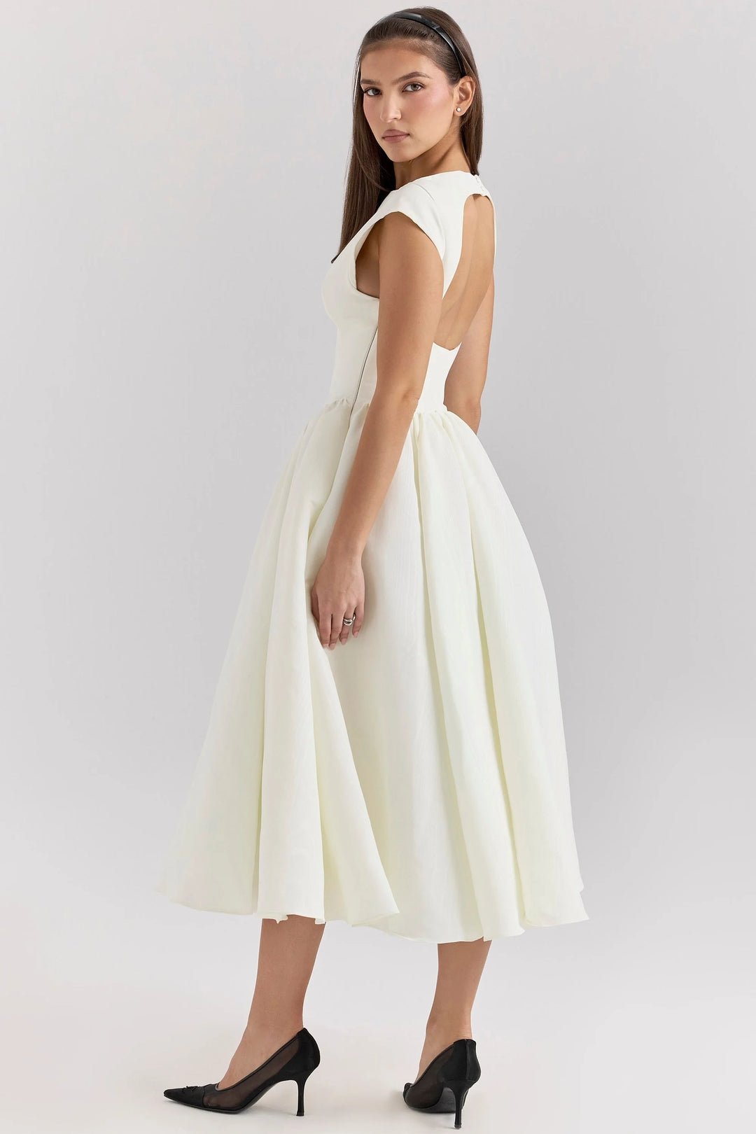 "Black mid-length dress with sculpted bodice and detailed stitching, perfect for elegant occasions."