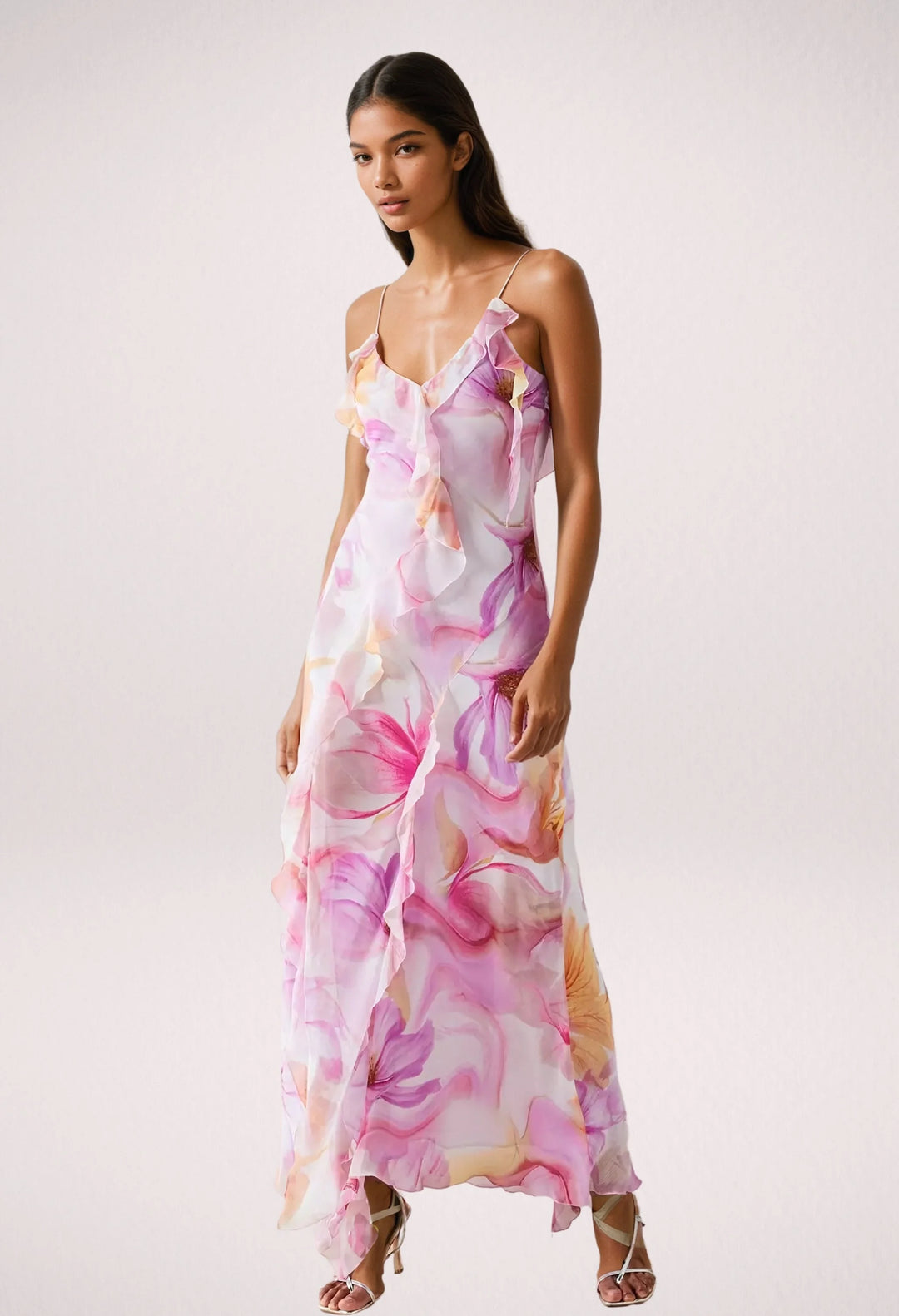 Sleeveless floral maxi dress with ruffle trim, worn by Viktoria. Made of lightweight cotton blend with vibrant floral pattern.