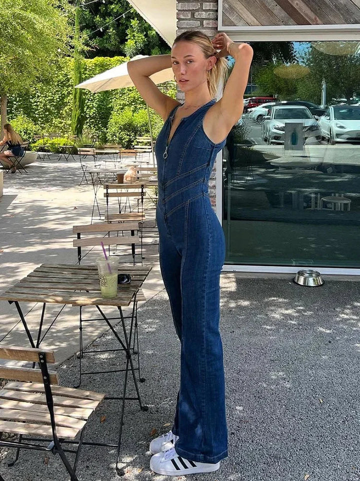 Blue denim jumpsuit with zipper, sleeveless, and a flattering cut. Perfect for a casual yet stylish look.