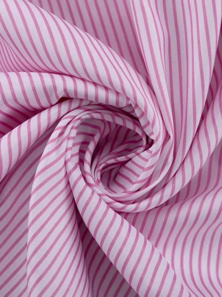 Striped pink dress with slit detail made from soft, lightweight fabric. Perfect for a chic and casual look.