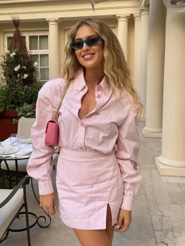 Alt text: "Pink striped dress with slit detail showcasing elegant design and relaxed fit, perfect for casual occasions."