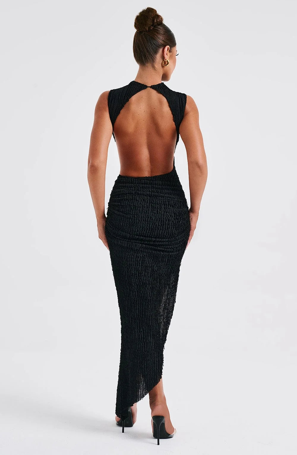 "Beige sleeveless maxi dress with side cut-out detail showcasing textured fabric for a trendy summer look."