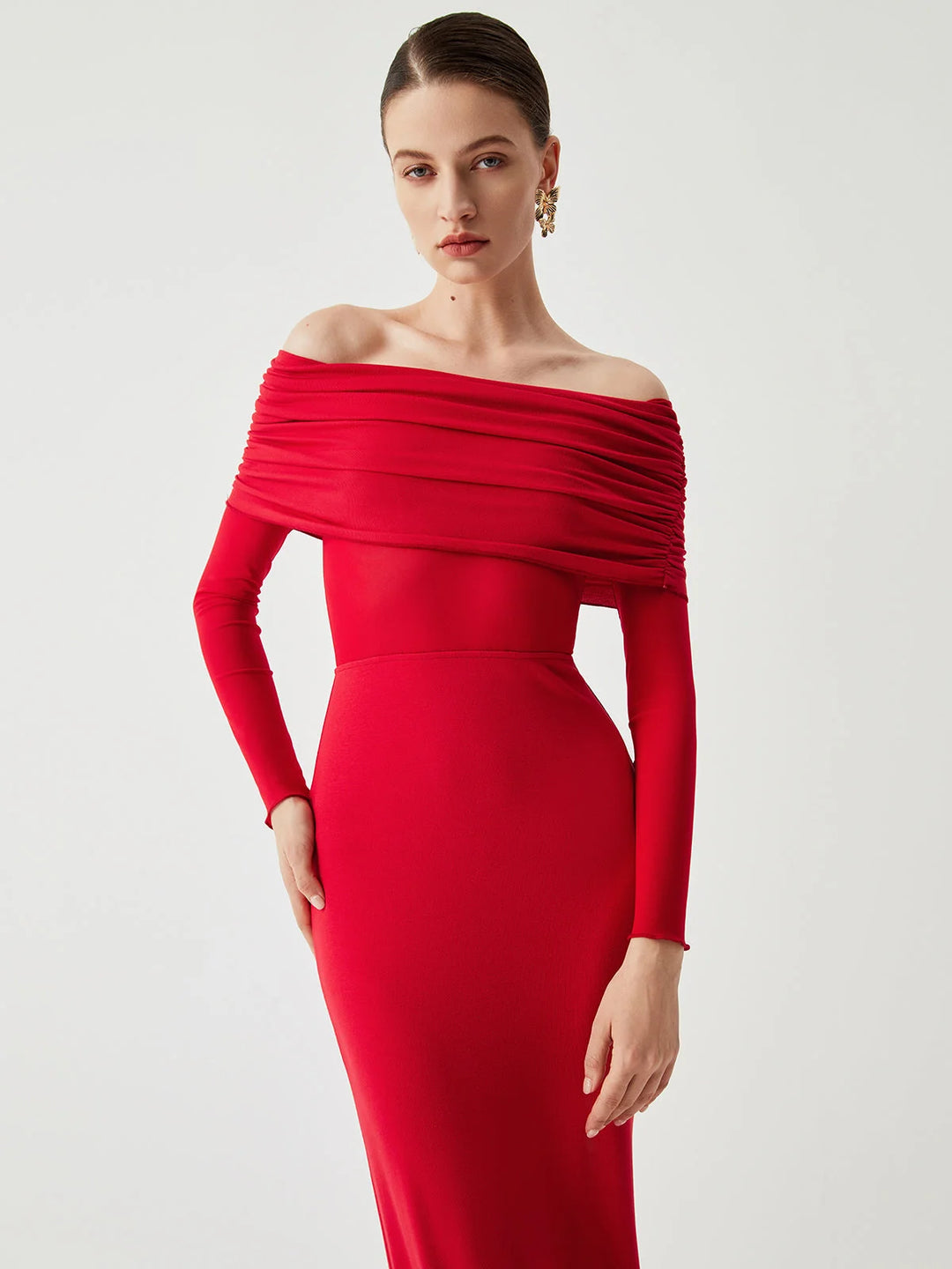 "Black off-shoulder dress with mesh sleeves, fitted silhouette. Stylish and elegant design for special occasions."