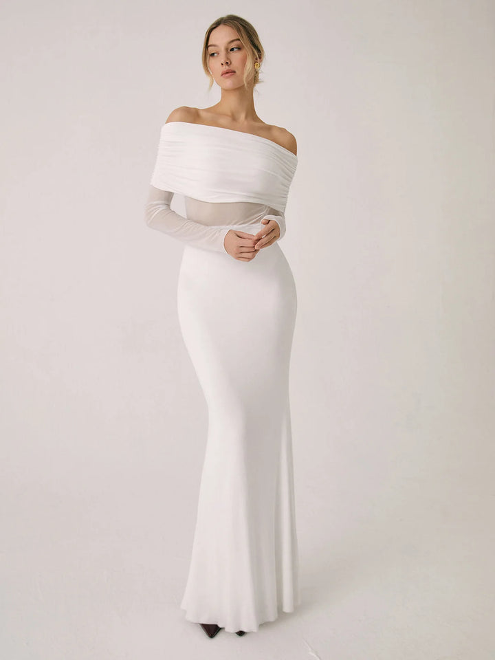 White off-shoulder dress with mesh sleeves, fitted silhouette.