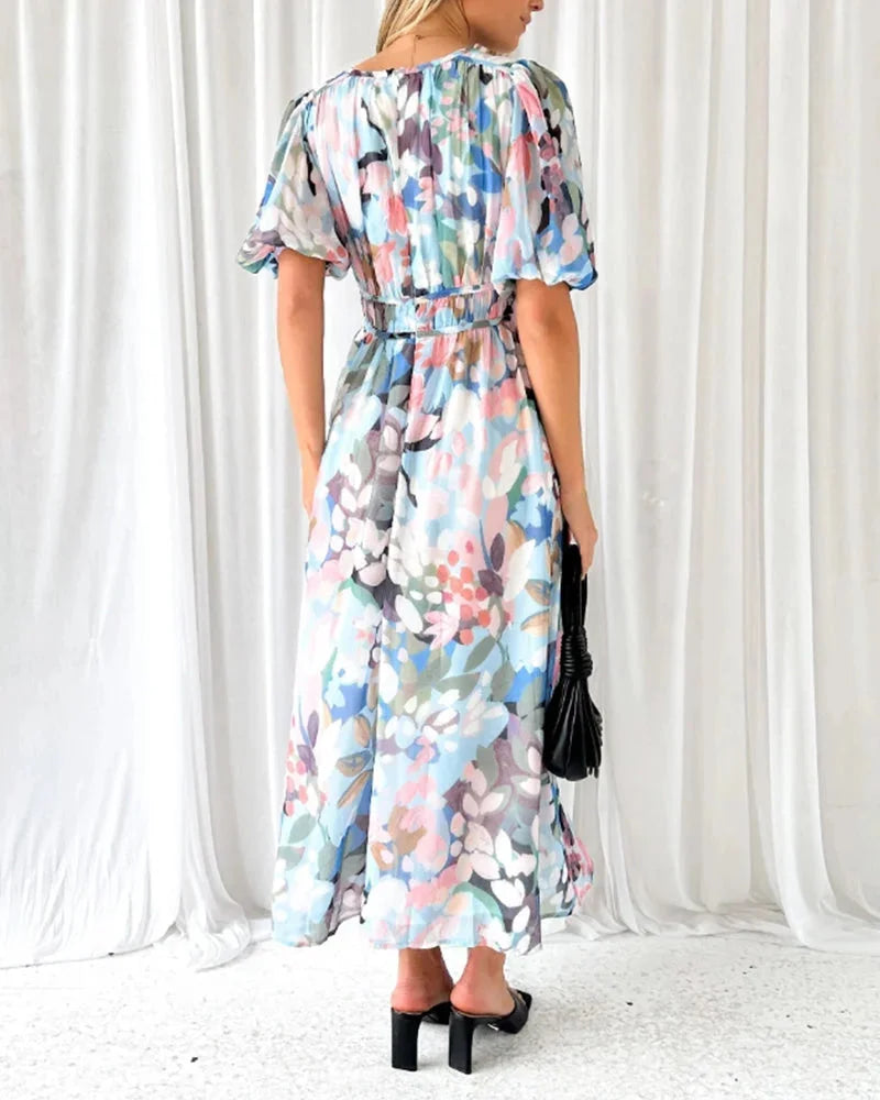 "Rhoda floral maxi dress featuring long sleeves, made of lightweight fabric with a vibrant floral pattern."
